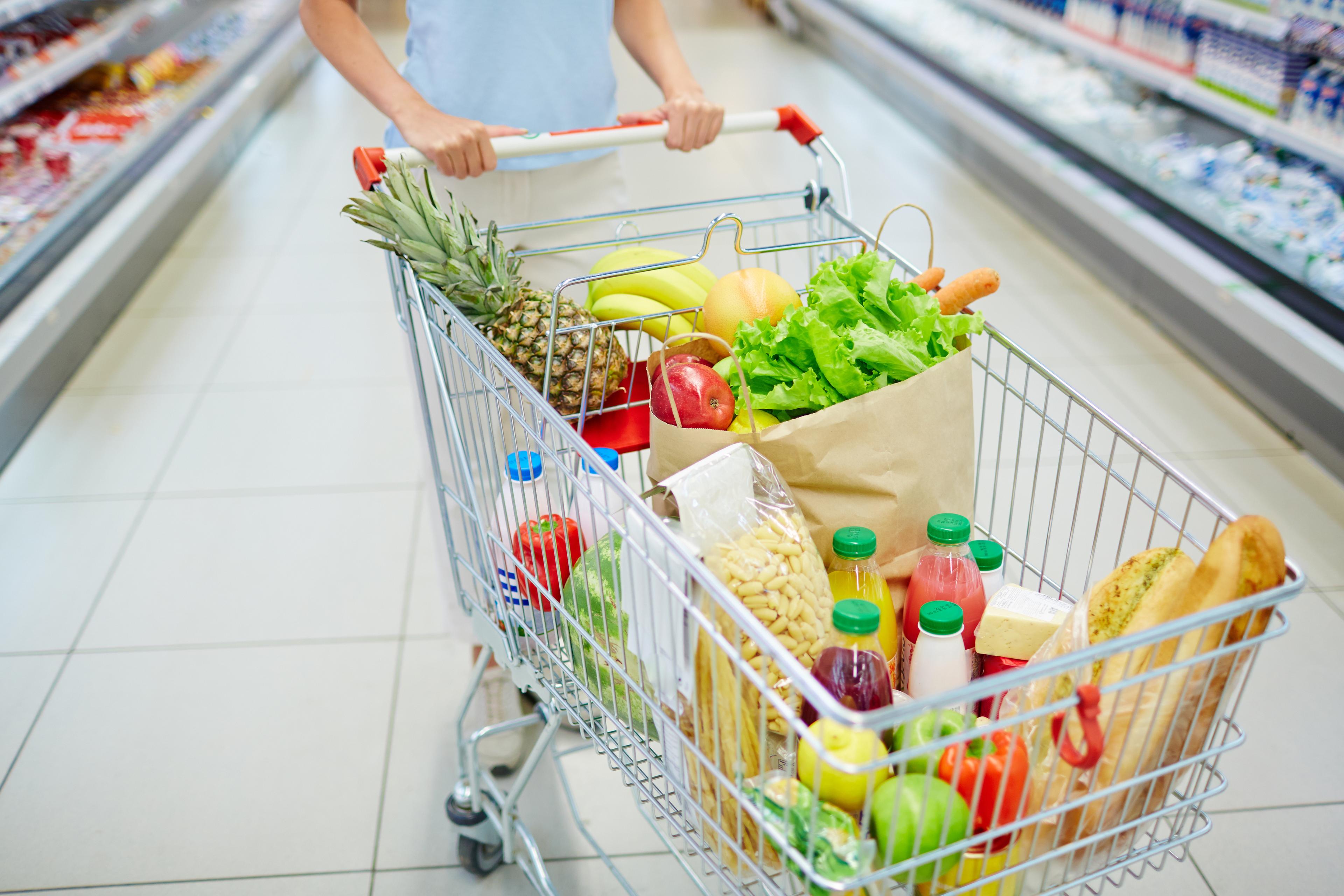 A cart filled with grocery items.