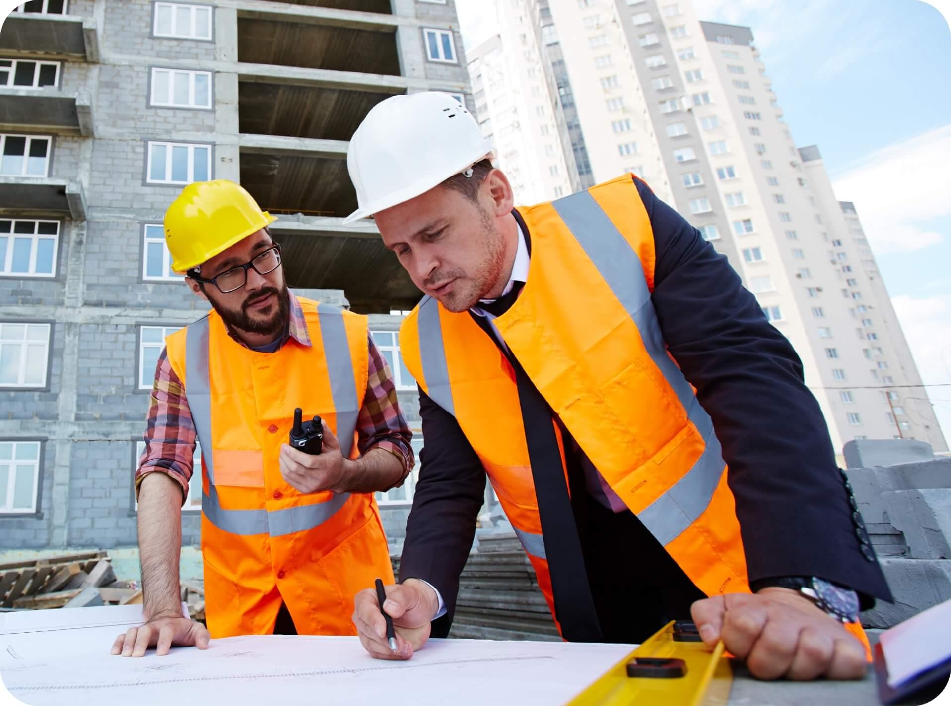 Two construction workers planning something for work