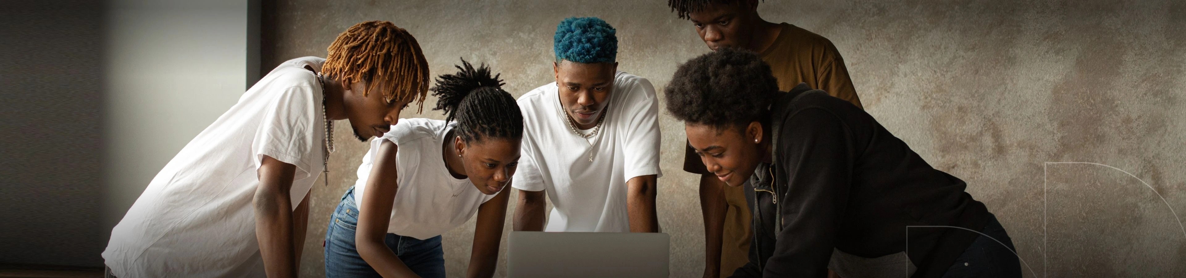 A group of people looking at the laptop for jobs