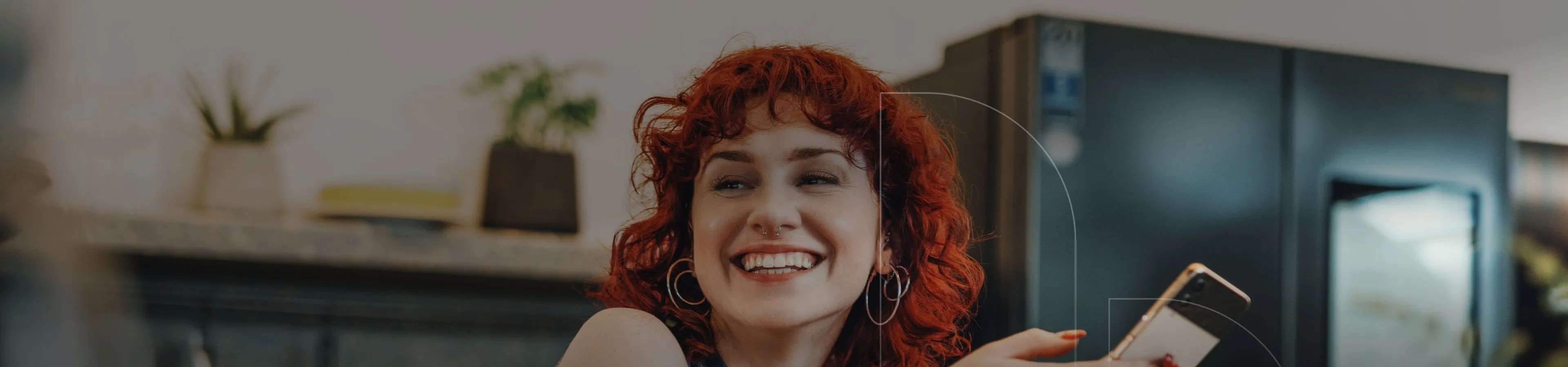 A women laughing by holding a phone