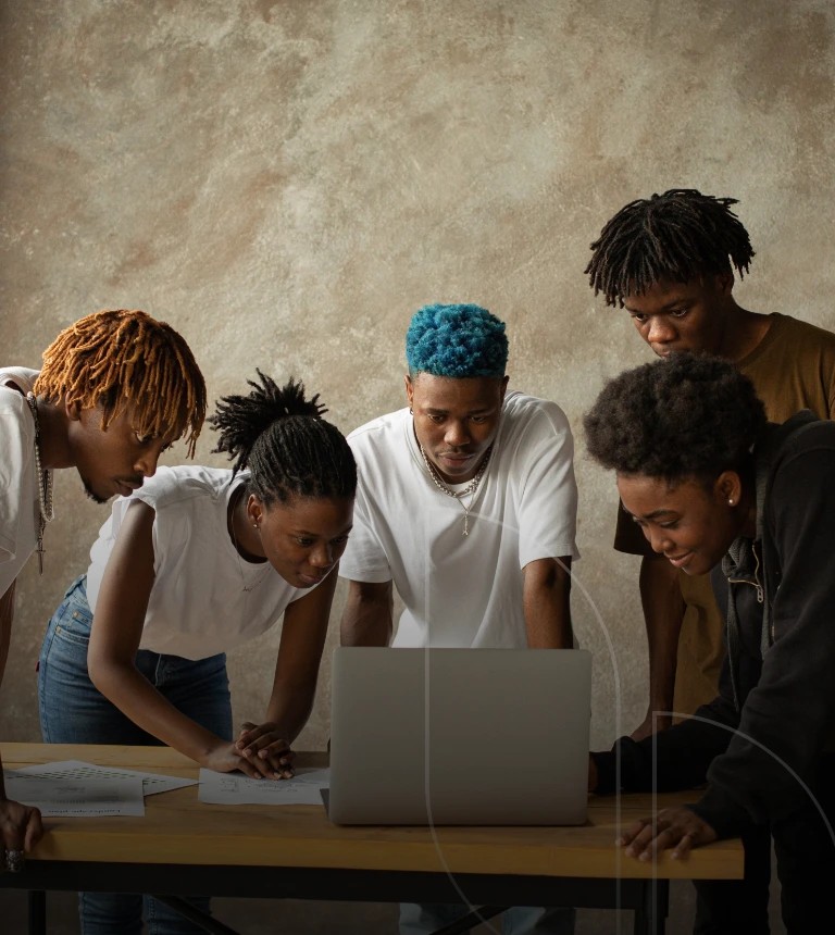 A group of people looking at the laptop for jobs